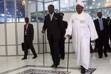 Chad President Idriss Deby walks with Sudan's President Omer Hassan al-Bashir (R) after arriving at Khartoum Airport February 7, 2013. (Reuters)