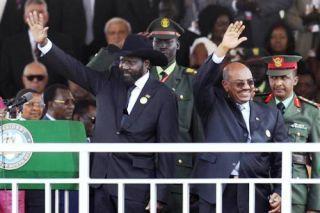 South Sudan's President Kiir and Sudan's President al-Bashir wave to the crowd during the Independence Day ceremony in Juba 09/07/2011 REUTERS/Thomas Mukoya