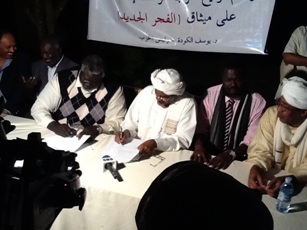 Youssef al-Koda, head of the Al-Wasat Islamic party, sits next to the chairman of the Sudan People Liberation Movement-North (SPLM-N), Malik Agar, at the signing ceremony in Kampala, Uganda on 31 January 2013