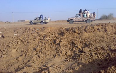 Militiamen riding two vehicles near Kutum in North Darfur state. JEM says they are accompanying some Malian jihadists (Photo released by JEM spokesperson in Feb 2013)