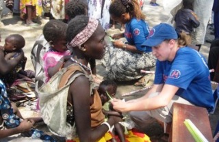 A MEDAIR worker attends to a malnourished child at a health unit in Pibor Boys Primary School, 2 January 2012 (ST/Julius Uma)