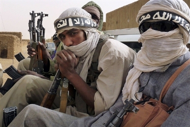 Militiaman from the Ansar Dine Islamic grou ride on a vehicle at Kidal in northeastern Mali  on June 16, 2013 (Reuters)