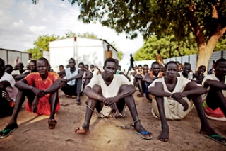 Inmates at Unity state's Bentiu Prison sitting in the prison courtyard (HRW)