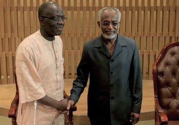 Paul Paulo Soso, African Union ambassador and chairman of the current session, shakes hands with Sudanese Foreign Minister Ali Karti (R) in the capital Khartoum on March 17, 2013 (ASHRAF SHAZLY/AFP/Getty Images)