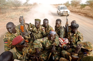 Sudanese Peoples Liberation Army (SPLA) soldiers drive in a truck on the frontline in Panakuach on April 24, 2012 (Goran Tomasevic/Reuters)