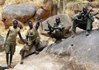 A SPLA-N fighter holds up his rifle near Jebel Kwo village in the rebel-held territory of the Nuba Mountains in South Kordofan on 2 May 2012 (Photo: Goran Tomasevic/Reuters)