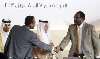 Sudan's Liberation and Justice Movement (LJM) leader al-Tijani al-Sissi  (R) shakes hands with Sudanese presidential adviser Mustafa Osman Ismail (L) during the International Donor Conference for Reconstruction and Development in Darfur, in Doha April 8, 2013 (Photo: Reuters/Mohammed Dabbous)
