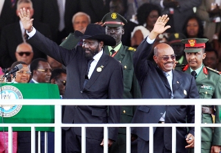 South Sudan’s President Salva Kiir and Sudan’s President Omar Hassan al-Bashir wave to the crowd during the Independence Day ceremony (Reuters)