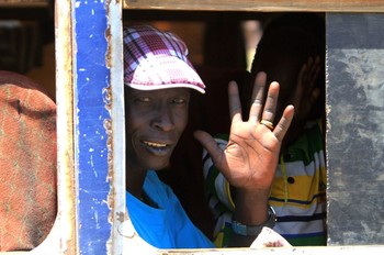 A South Sudanese man waves as he sits on a bus waiting to leave the Sudanese capital Khartoum on March 19, 2013. (ASHRAF SHAZLY/AFP/Getty Images)