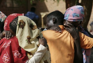 Displaced Sudanese people from the district of Abu Kershola, comfort each other at a camp on April 29, 2013 in the North Kordofan town of El Rahad. )EBRAHIM HAMID/AFP/Getty Images)
