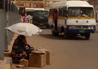 A woman sells peanuts on the side of the road in Khartoum's souq al-Arabi (ST)