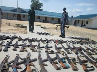 South Sudanese police standing by recently confiscated guns in Bor, Jonglei state, May 30, 2013 (ST)