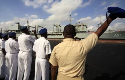 Sudanese naval officials wave as the Iranian Navy helicopter-carrier Kharg docks at Port Sudan in October 2012 (photo Press TV)