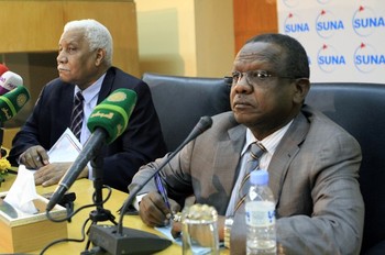 Sudanese Information Minister Ahmed Bilal Osman (L) sits next to the chief of Sudan's intelligence service Mohammed Atta (R) during a press conference in the Sudanese capital Khartoum on June 9, 2013 (ASHRAF SHAZLY/AFP/Getty Images)