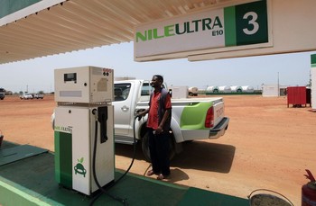 A worker fills a pickup truck's tank with blended fuel at the first blended fuel station at Kenana Sugar Company (KSC)'s main plant, 270 km (170 miles) south of Khartoum May 14, 2013. (REUTERS/Mohamed Nureldin Abdallah)