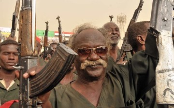 FILE - A Sudanese soldier holds his gun in the air during the visit of President Omer Hassan al-Bashir to the Popular Defence Forces (PDF) in Khartoum on March 3, 2012 (EBRAHIM HAMID/AFP/Getty Images)