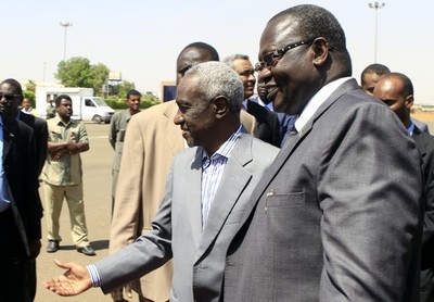 Sudan's Vice President Ali Osman Taha (L) welcomes his South Sudanese counterpart Riek Machar (R) upon the latter's arrival at Khartoum ariport on June 30, 2013 (Getty)