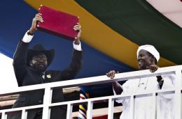 South Sudan President Salva Kiir holds the Transitional Constitution on July 9, 2011 (AP)