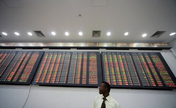 An engineer stands in front of a new electronic trading board at the Khartoum stock exchange April 25, 2011 (REUTERS/Mohamed Nureldin Abdallah)