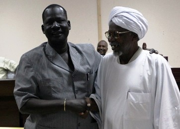 The late leader of the Dinka Ngok tribe, Kuol Deng Kuol (L), shakes hands with Misseriya chief Al-Amer Mokhtar Papo after signing a peace agreement in the town of Kadugli, north of Abeyi on 13 January 2011 (Khaled Desouki/AFP/Getty)