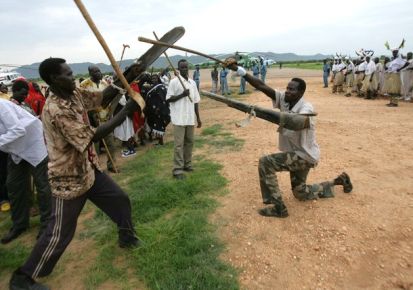 A local resident shows off their skills as they wait to greet Sudan's second vice-president, Ali Osman Taha, as he visits South Kordofan's state capital, Kadugli, on 3 August 2010 (Reuters)