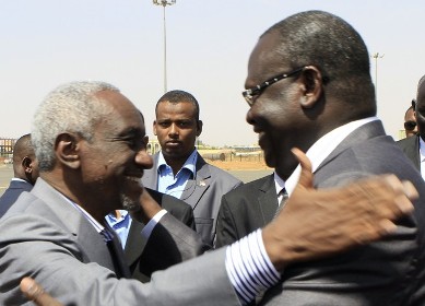 Sudan's Vice President Ali Osman Taha (L) greets his South Sudanese counterpart Riek Machar upon the latter's arrival at Khartoum ariport on June 30, 2013. (Getty)