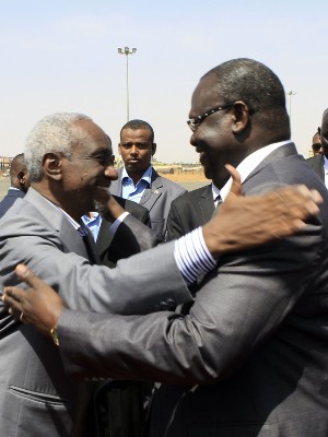 Sudan's Vice President Ali Osman Taha (L) greets his South Sudanese counterpart Riek Machar upon the latter's arrival at Khartoum airport on June 30, 2013. Machar and Talah discussed ways to ease tensions after Khartoum threatened to halt oil flows. The two parties recommitted themselves to the Cooperation Agreement and its implementation. (Photo ASHRAF SHAZLY/AFP/Getty Images)