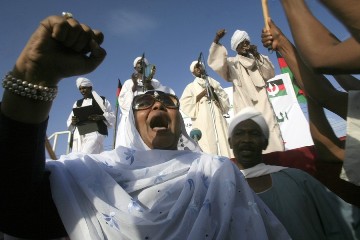 A female supporter of former prime minister (1986-1989) and now head of the National Umma Party (NUP), religious leader al-Sadiq al-Mahdi, rally in Khalifa Square in Sudan's twin capital of Omdurman on 29 June 2013 (Photo: Ashraf Shazly/AFP/Getty Images)