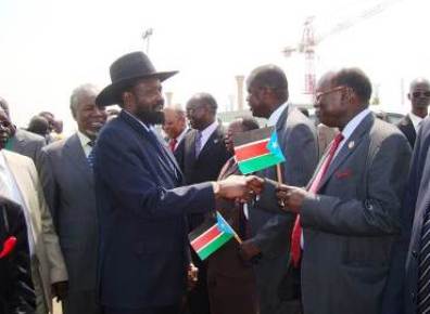 A file photo where President Salva Kiir shakes hands with minister Barnaba Marial Benjamin (Photo Moses L. Lomayat)
