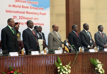 Sudanese President Omer Hassan Al-Beshir (C) stands among speakers before the opening of the African bloc meetings of finance ministers and central bank governors on August 21, 2013 in the Sudanese capital Khartoum (ASHRAF SHAZLY/AFP/Getty Images)