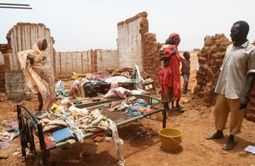 A family gathers their belongings in the courtyard of a home following heavy rains which destroyed the mainly mud brick houses in Omdurman, some 30 kilometers northwest of the Sudanese capital Khartoum, on August 13, 2013 (ASHRAF SHAZLY/AFP/Getty Images)