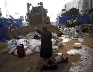 An Egyptian woman tries to stop a military bulldozer from hurting a wounded youth during clashes that broke out as Egyptian security forces moved in to disperse supporters of Egypt's deposed president, Mohamed Morsi, in a huge protest camp near Rabaa al-Adawiya mosque in eastern Cairo, Aug. 14, 2013. (Mohammed Abdel Moneim/AFP/Getty Images)