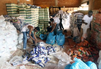 Sudanese volunteers prepare bags ahead of a distribution of goods donated by Qatar to help the population following the heavy rains and flash floods that hit the country on August 15, 2013 in the capital Khartoum (ASHRAF SHAZLY/AFP/Getty Images)