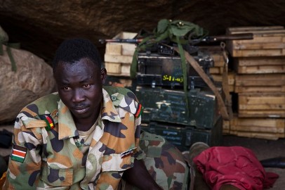 A SPLA-N rebel soldier sits amongst ammunition that was seized from the Sudan Armed Forces (SAF) during fighting in the Nuba Mountains, in South Kordofan on 25 April 2012 (Photo: ADRIANE OHANESIAN/AFP/GettyImages)