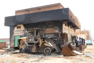 A picture taken on September 26, 2013 in the Sudanese capital Khartoum shows a digger and a building that were damaged in the rioting that erupted following a decision of the government to scrap fuel subsidies (AFP/Getty Images)