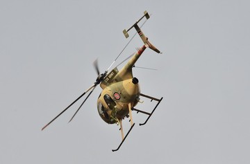 A Kenyan army helicopter flies low near Westgate mall in Nairobi on September 22, 2013 (CARL DE SOUZA/AFP/Getty Images)