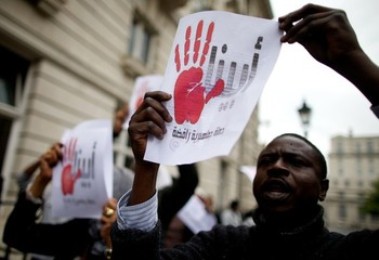 Members of the campaign group Sudan Change Now protest outside the Sudanese embassy in London on September 28, 2013 during a demonstration about the NCP regime and its brutal attacks' on Sudanese protestors  (Photo Andrew Cowie/AFP/Getty Images)