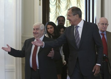 Russia's Foreign Minister Sergei Lavrov (R, front) shows the way to his Syrian counterpart Walid Moualem (L) during a meeting in Moscow September 9, 2013 (REUTERS/Sergei Karpukhin)