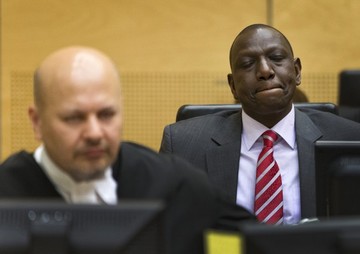 Kenya's Deputy President William Ruto, right, awaits the start of his trial in the courtroom of the International Criminal Court (ICC) in The Hague, Netherlands, Tuesday, Sept. 10, 2013 (AP Photo//Michael Kooren, Pool)