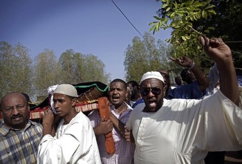 Sudanese men chant slogans as they carry the body of Salah Sanhory, 26, who was killed on Friday Sept. 27, 2013 by security forces, during his funeral in Khartoum, Sudan, Saturday, Sept. 28, 2013 (AP Photo/Khalil Hamra)