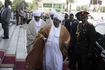 Sudanese president Omer Hassan al-Bashir arrives at the opening of a new session of parliament in Khartoum on 28 October 28 2013 (AFP/Getty Images)