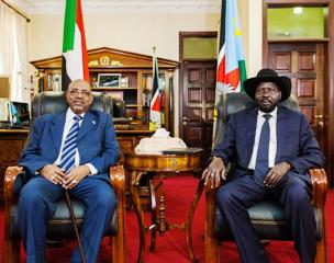 President Omar al-Bashir (L) poses for a photograph with his host, South Sudan's President Salva Kiir, at the latter's office in Juba October 22, 2013 (Adriane Ohanesian/Reuters)