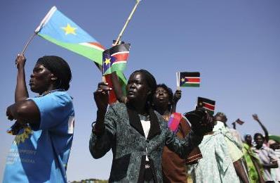 Women wave South Sudan's flags during a rally in the town of Abyei ahead of the referendum October 26, 2013. (Photo Reuters/Goran Tomasevic)