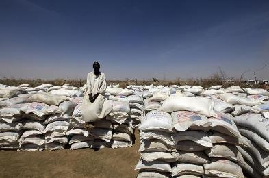 A man guards sacks of food at a food distribution centre  at Shangli Tobay village in North Darfur, in this June 18, 2013 ( Reuters)