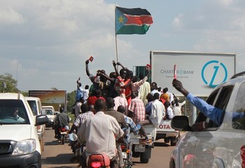 Ethnic group Ngok Dinka people celebrate with a South Sudanese flag in Juba on October 31, 2013, the results of an unofficial referendum of residents of contested region Abyei to decide if it lies in Sudan or South Sudan (WAAKHE SIMON/AFP/Getty Images)