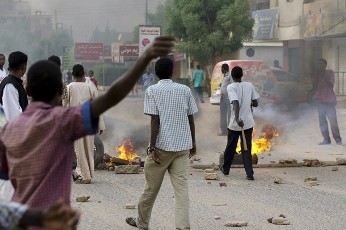 Sudanese anti-government protesters chant slogans during a demonstration in the Sudanese capital, Khartoum, in September 2013 (Photo: Khalil Hamra/AP)