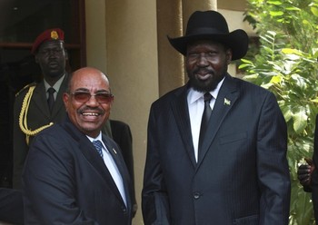 South Sudan's president, Salva Kiir, (R) welcomes his Sudanese counterpart, Omer Hassan al-Bashir outside his oresidential office in Juba on 12 April 2013 (Reuters)