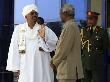 Sudanese president Omer Hassan al-Bashir is welcomed by vice-president Ali Osman Taha after arriving at Khartoum airport on 31 March 2011 (Photo: REUTERS/Mohamed Nureldin Abdallah)