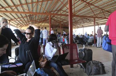 Locals and foreign nationals gather at Juba International Airport as they wait for flights out of the South Sudanese capital Juba December 18, 2013 (Reuters/Hakim George)