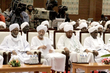 From left to right: Leader of the Popular Congress Party (PCP) Hassan Al-Turabi, Reform Now Party (RNP) head Ghazi Salah Al-Deen Al-Attabani, National Umma Party (NUP) Al-Sadiq Al-Mahdi and second vice-president Hassabo Abdel-Rahman attend a speech by the president announcing a national dialogue initiative on 27 January 2014 (SUNA)